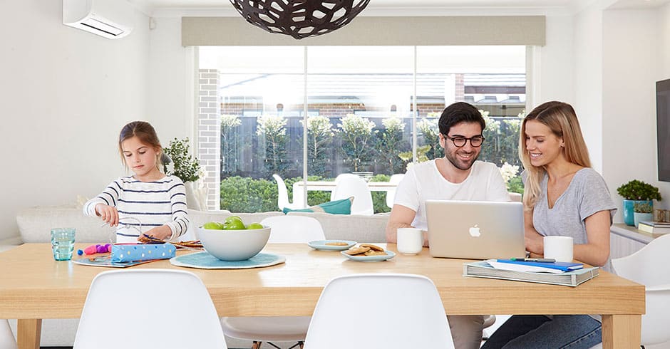 A family enjoying cool air from their air conditioner