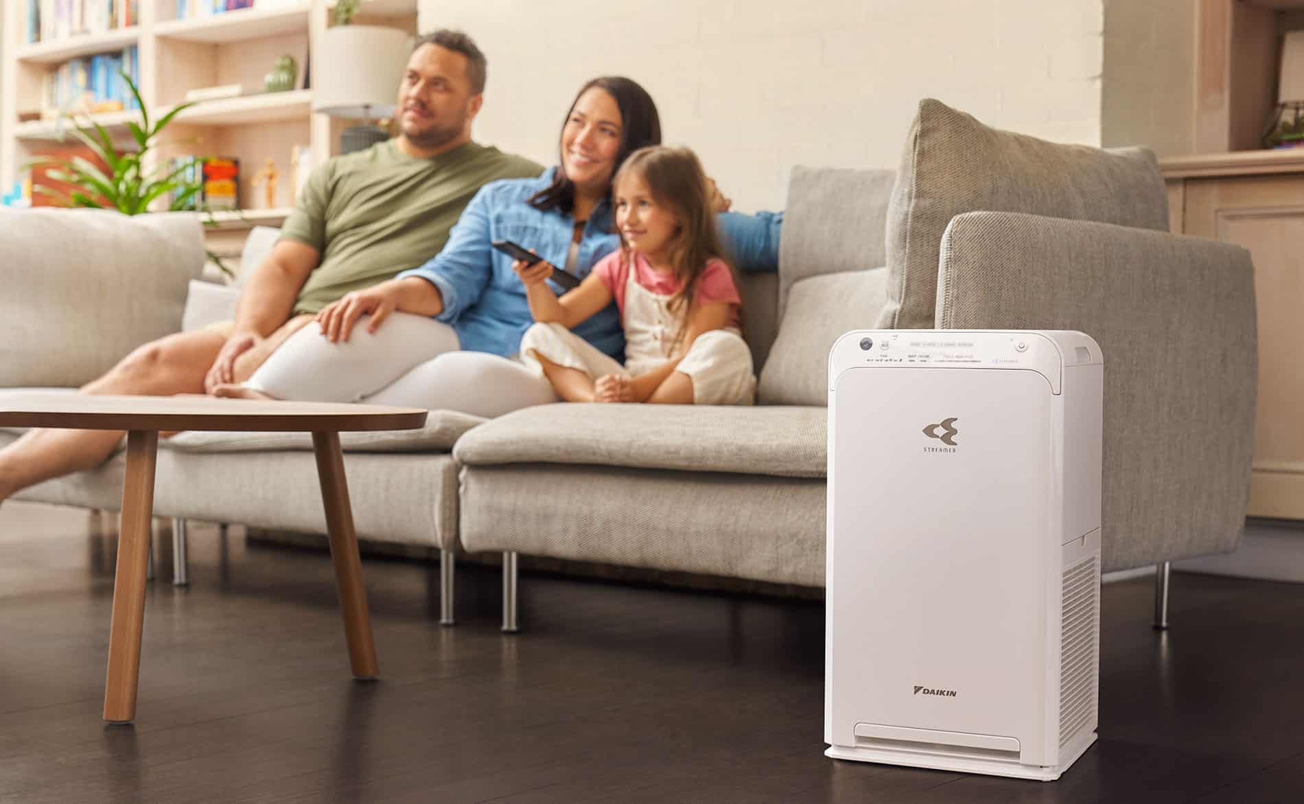 Family in living room with Daiken air purifier running